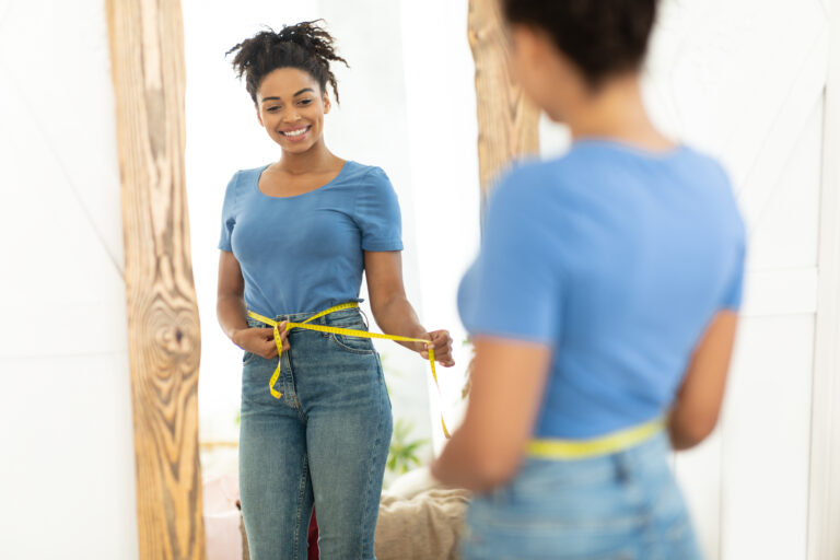 HAPPY BLACK GIRL AFTER WEIGHT LOSS MEASURING WAIST 2023 11 27 05 35 21 UTC 768X512 1